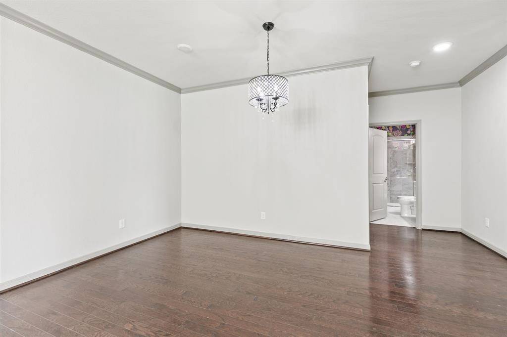 Dining room area features an updated light fixture and is also open to the kitchen and family room.