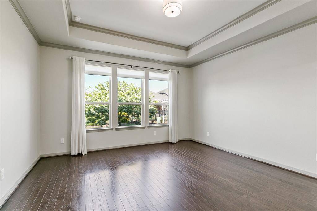 Primary bedroom overlooks the gorgeously landscaped backyard.