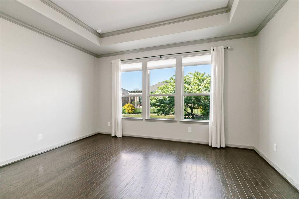 Wood flooring was extended to this room, as well, and tray ceiling is an upscale touch.
