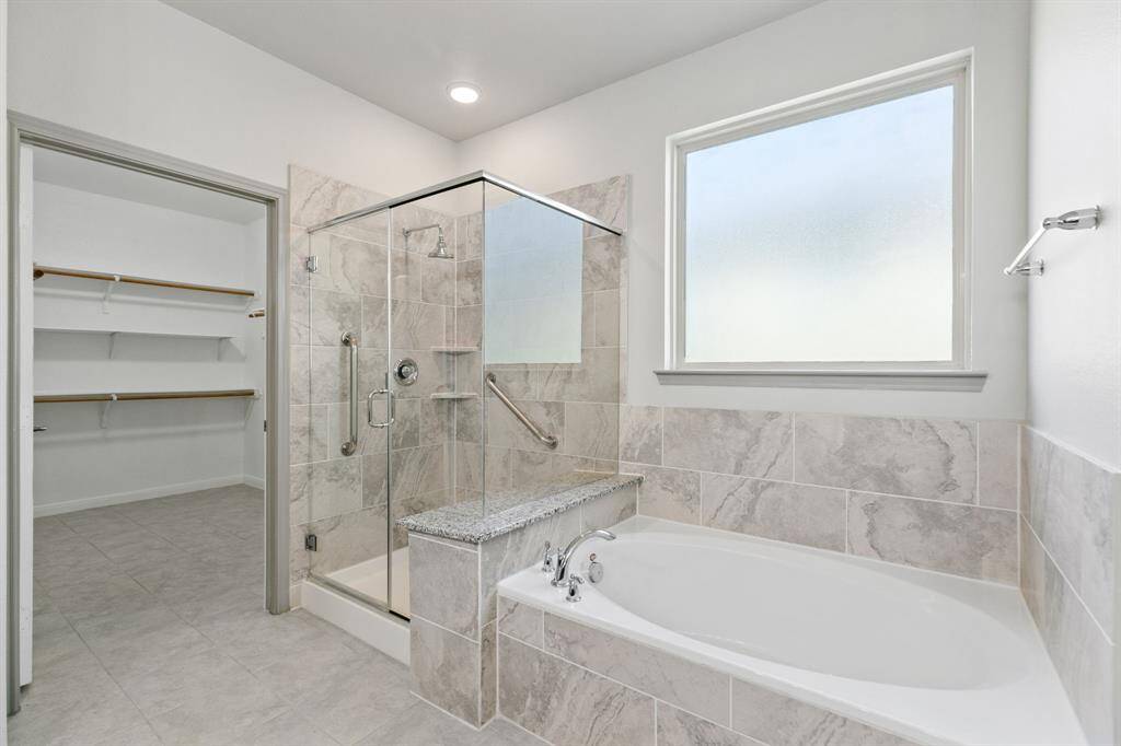 Garden tub is separate from oversized shower.