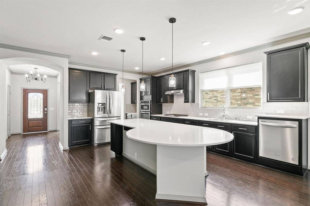 The kitchen features an oversized island, which is great for entertaining. The breakfast bar is a bonus for plentyn of stools, and the kitchen has all the bells and whistles. It’s a chef's dream.