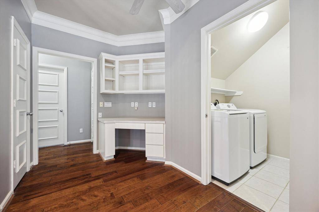 The laundry room (washer and dryer included in lease) is located around the corner from the primary bedroom and the secondary bedrooms on the 2nd floor.