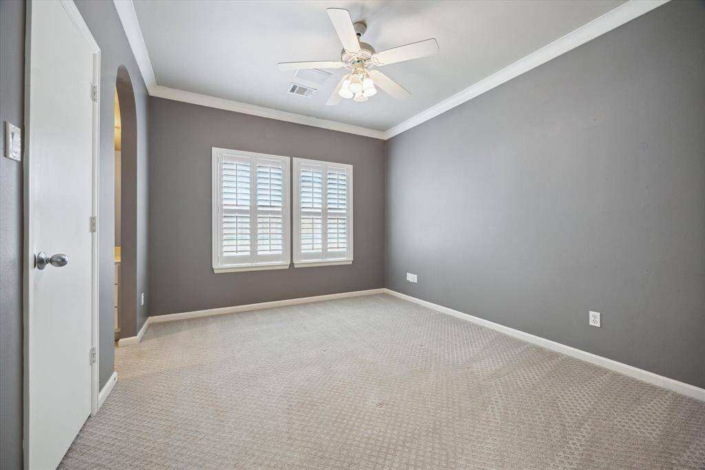 The second, secondary bedroom located at the end of the walkway on the 2nd floor. Walk-in closet to the left.
