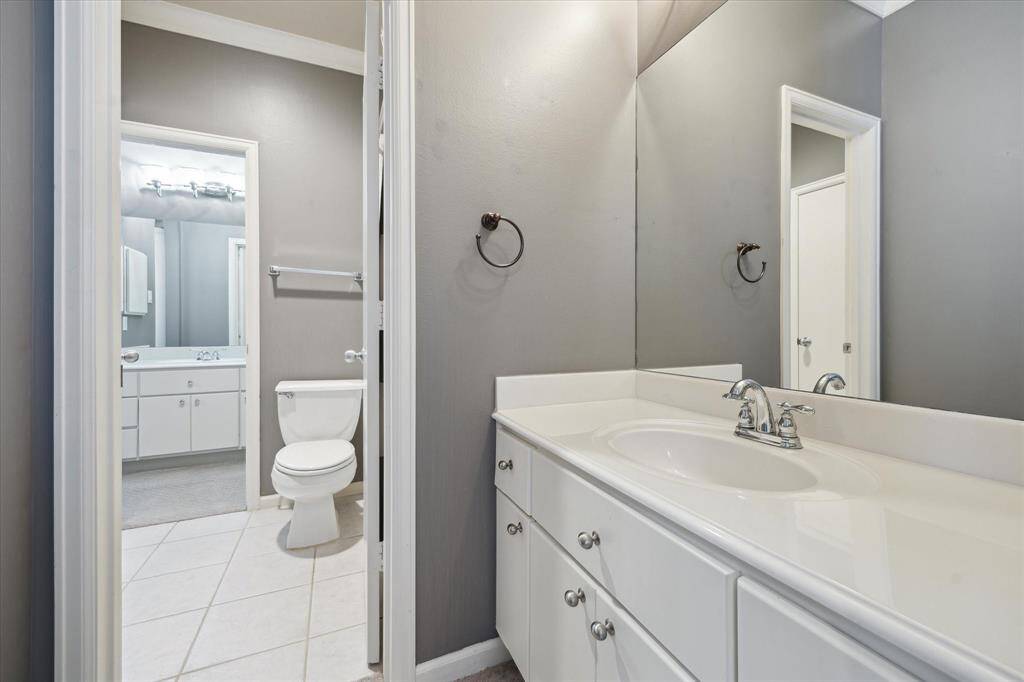 Picture of the second, secondary sink and cabinets, with the Jack and Jill in the background with a shower/tub combo, a towel closet, and the other sink/cabinet in the background for the other secondary bedroom.