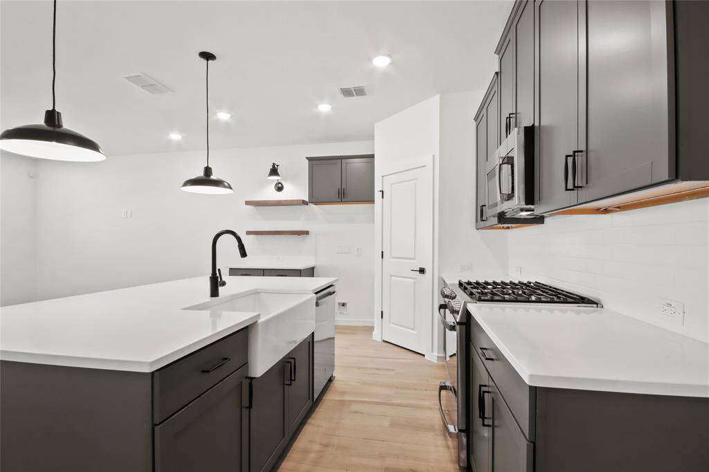 Kitchen with quartz counters and matte black accents (*Photo not of actual home and used for illustration purposes only.)