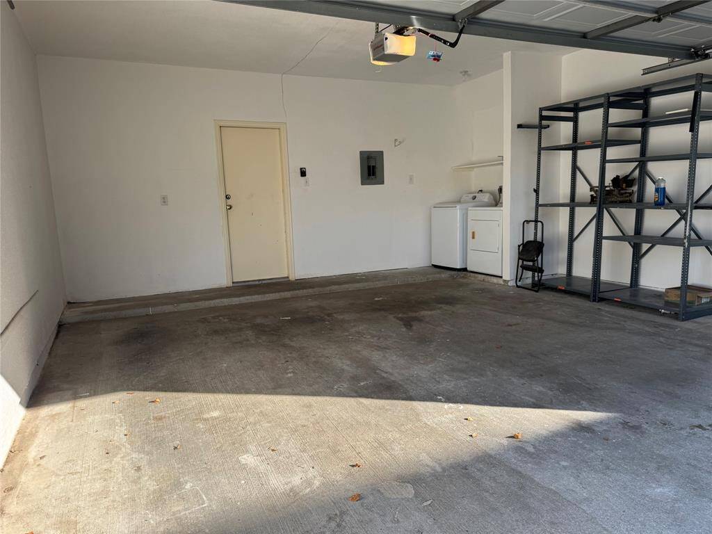 Garage features a spacious layout, washer and , and a door leading into the home. Perfect for parking and additional storage needs.