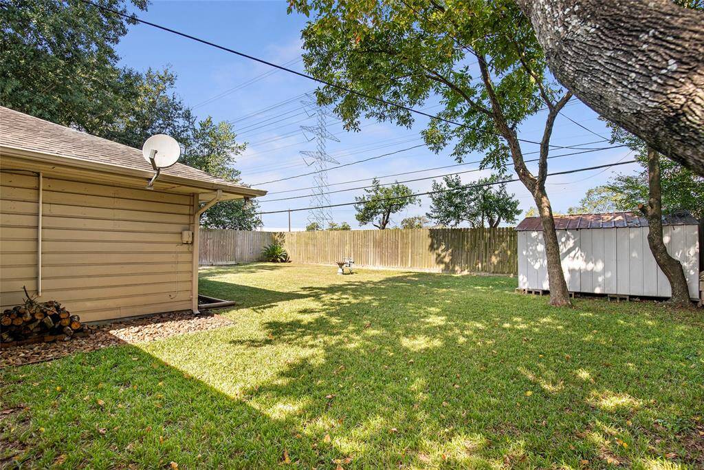 Shaded side yard and an available storage building.