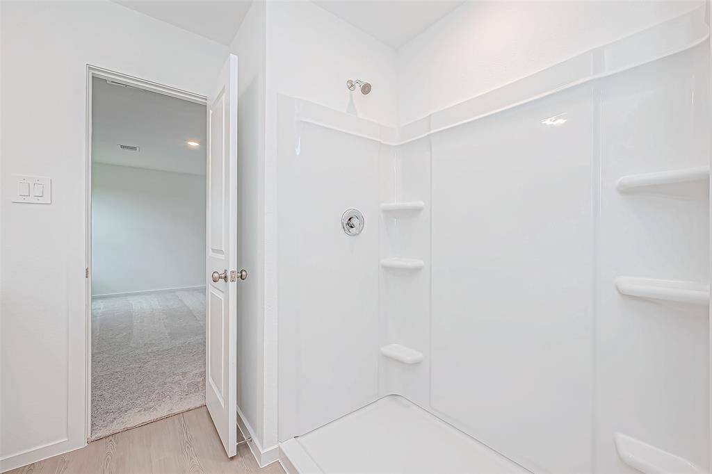Large, spacious shower in the primary bathroom.