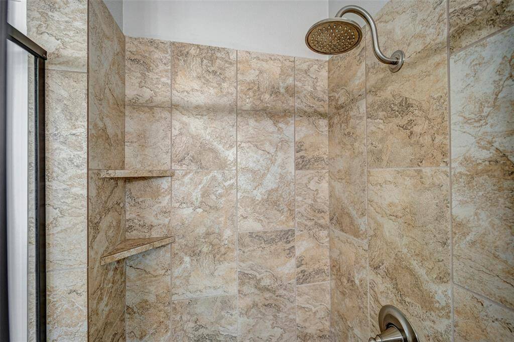Primary bath with double sinks, separate tub and stand-alone shower.