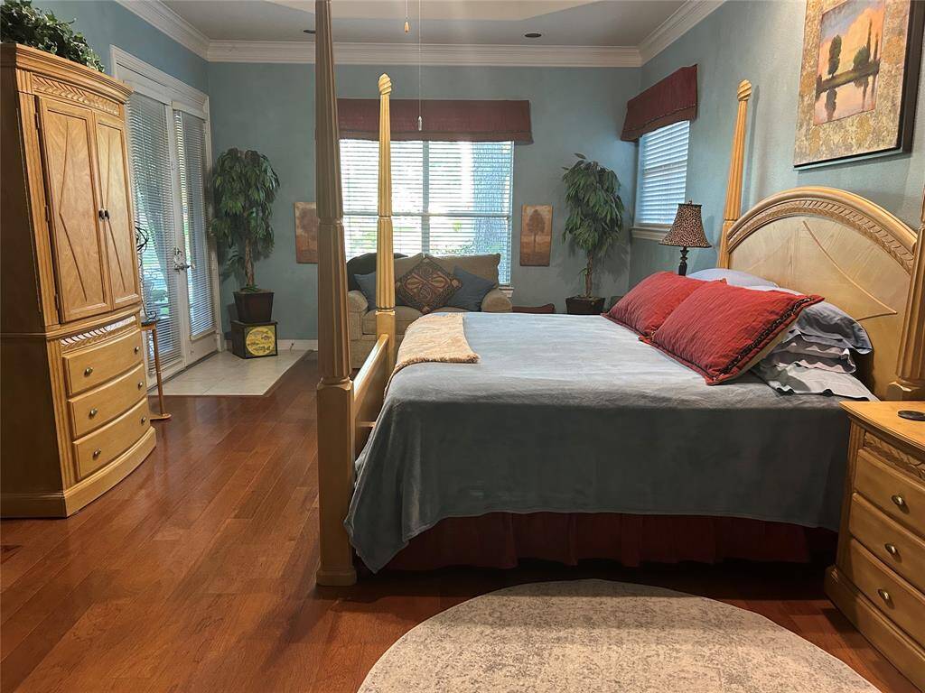 Primary bedroom with sitting area and French doors leading to back yard oasis