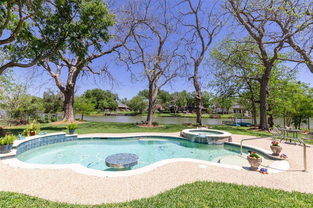 3 car tandem garage with epoxy floors leading to backyard paradise