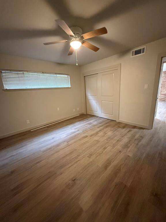Primary bedroom with new ceiling fan is at back of unit off quiet, private patio.