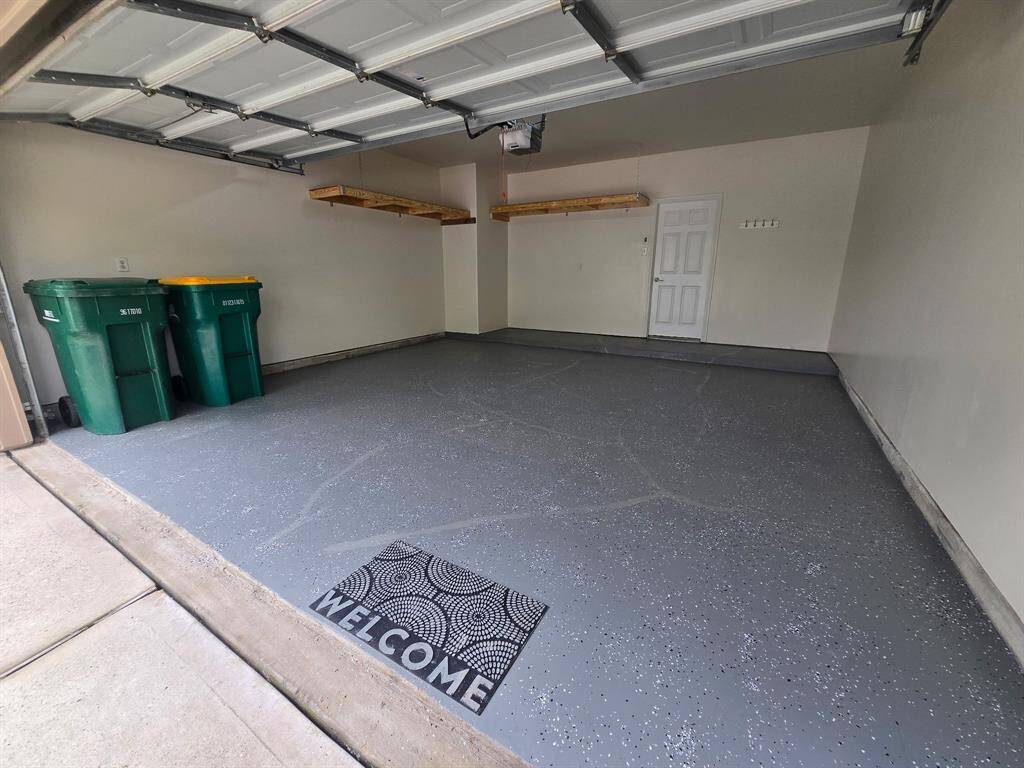 Garage has beautiful new epoxy and new convenient storage shelves