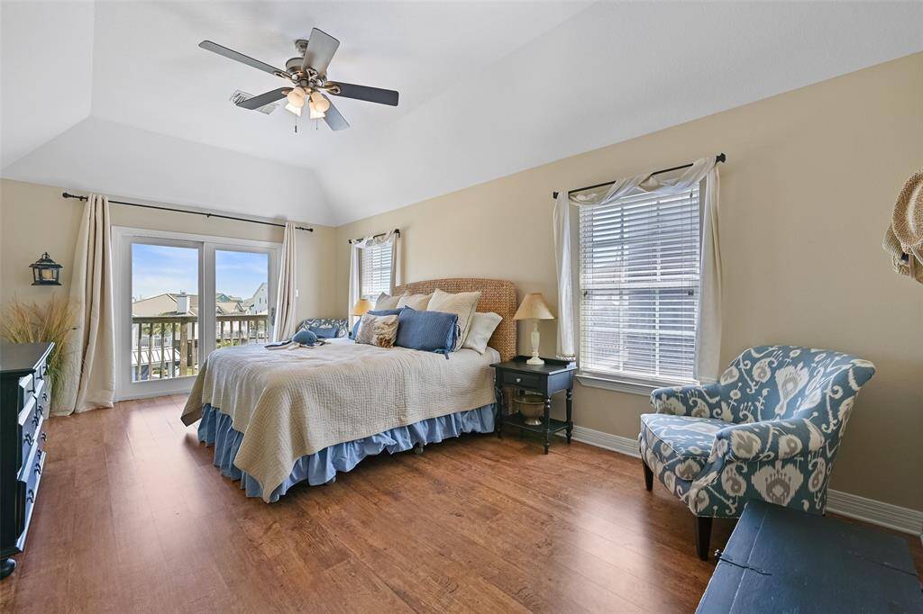 Luxurious primary suite with canal views and a cozy sitting area.