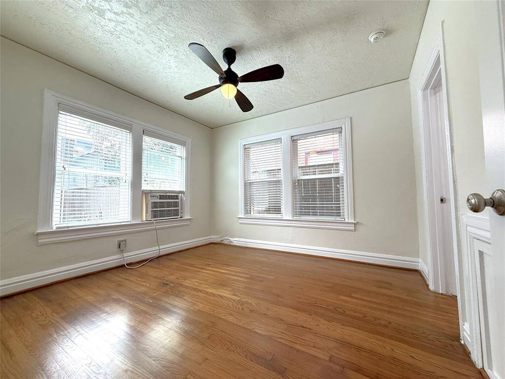 The back bedroom with ceiling fan/light.