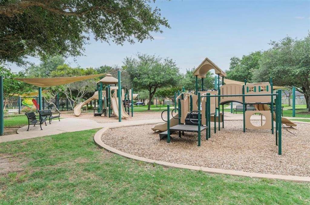 This resort-style community pool complex features winding water slides, a relaxing lagoon-style pool, splash zones for kids, and tranquil lounging areas shaded by pergolas. Nestled along the scenic lake. Excellent for relaxation and recreation for residents.