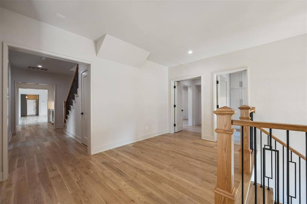 A dream-worthy primary closet, this space is impeccably finished with custom built-ins, a center island with soft-close drawers, and abundant natural light from surrounding windows. With thoughtful storage and dressing areas, it’s designed to elevate your daily routine with elegance and ease.