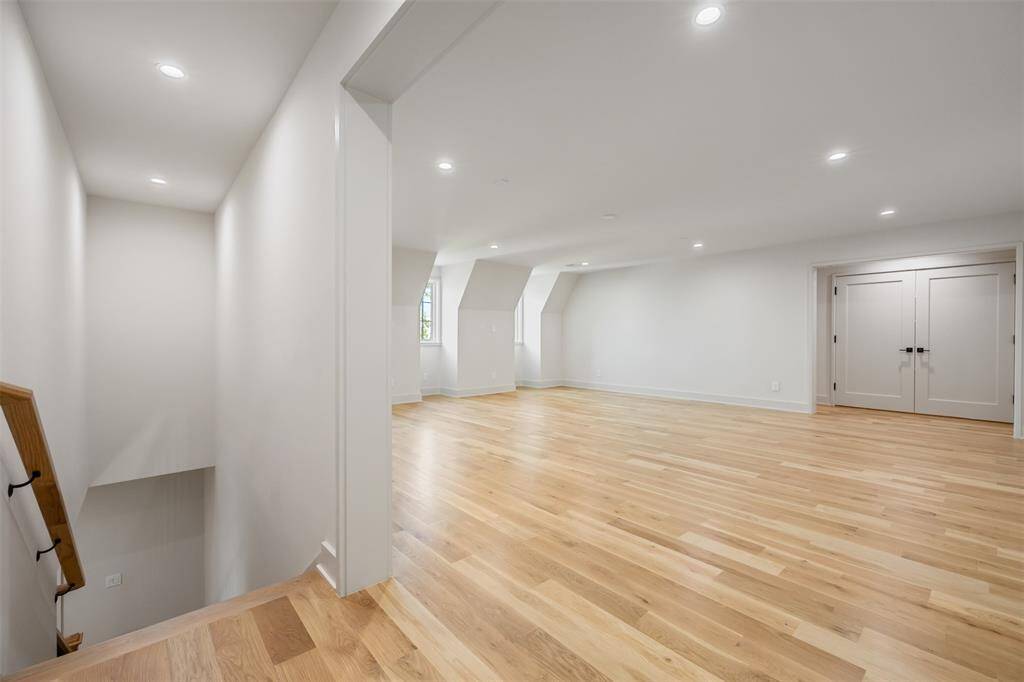 Flooded with natural light, this secondary walk-in closet is thoughtfully appointed with open shelving, abundant drawers, and tailored hanging space. Designed with both beauty and function in mind, it offers a boutique-style experience in the comfort of home.