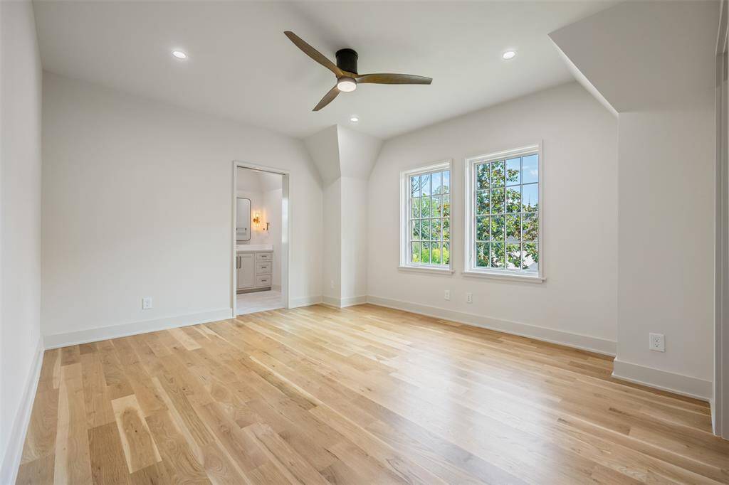The primary suite’s oversized walk-in shower is a retreat of its own—wrapped in floor-to-ceiling designer tile and outfitted with dual rain heads, body sprays, and a built-in bench. Gold-toned fixtures and thoughtful lighting add a warm, spa-like ambiance to this exquisite daily escape.
