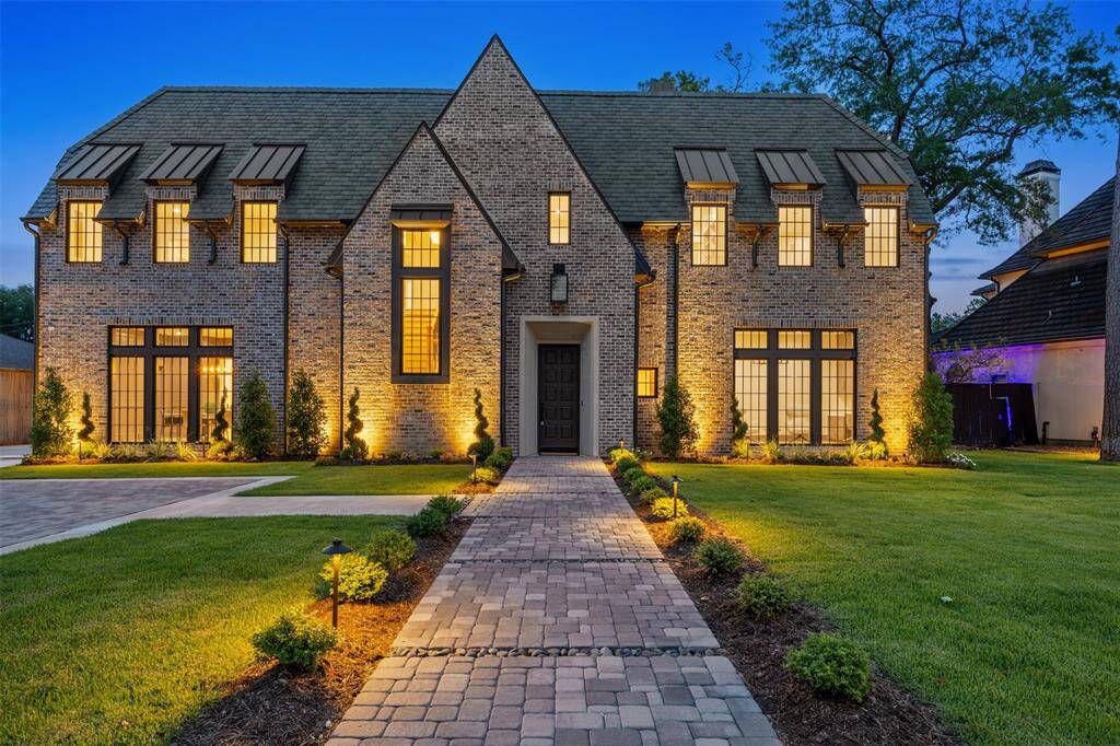 This expansive covered patio is a true extension of the home’s luxurious living space, complete with exposed wood beams, a ceiling fan, and a brick fireplace that anchors the ambiance. Overlooking the shimmering pool, it’s the perfect setting for alfresco dining, summer gatherings, or quiet evenings under the stars.