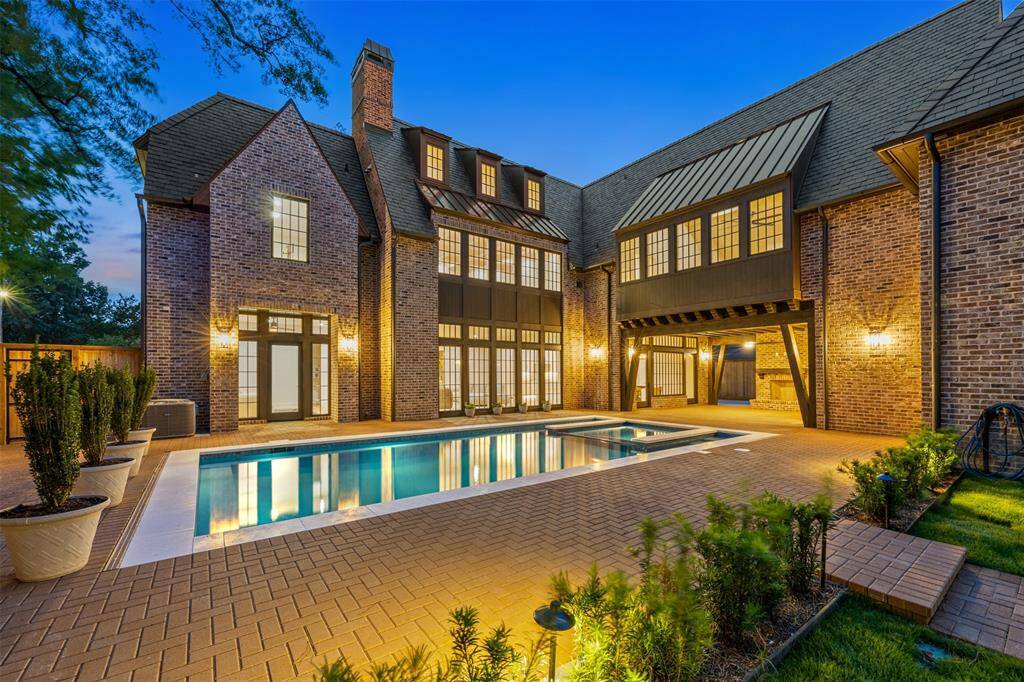 This aerial view captures the home’s grand scale and architectural elegance, framed by manicured lawns and mature trees. From the slate roof to the expansive driveway and resort-style backyard, every inch of the property reflects a commitment to luxury living and timeless design.