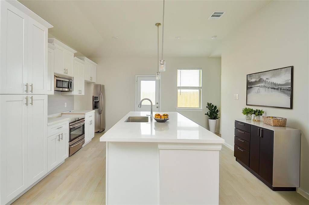 It features sleek cabinetry, modern appliances, and a functional layout.