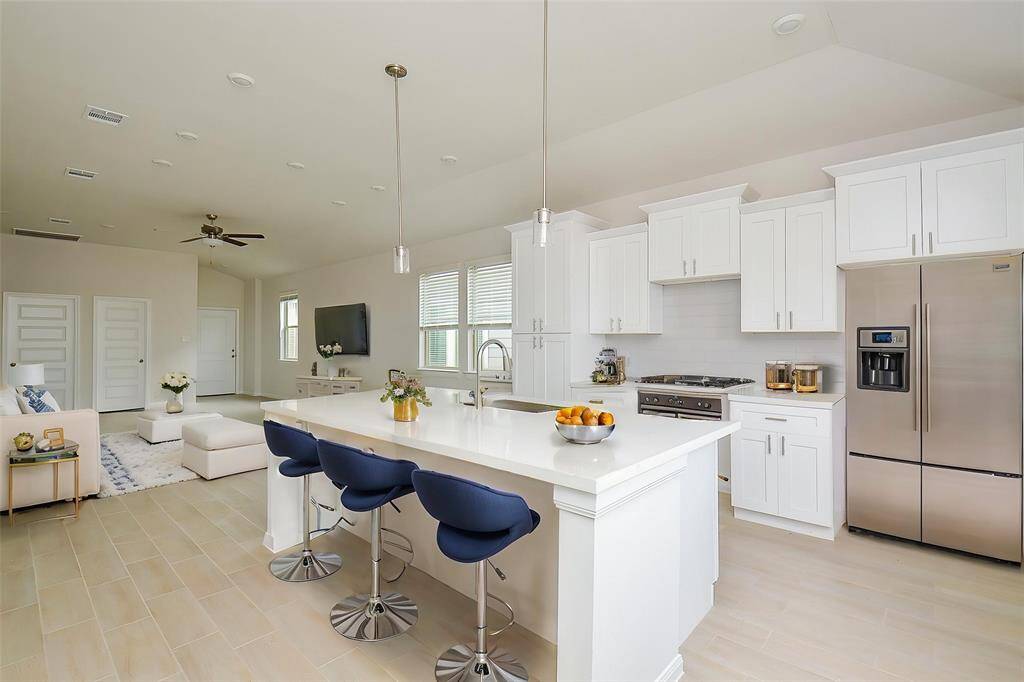 Imagine hosting dinner parties, preparing meals in the stylish kitchen, and enjoying quality time with loved ones in this open, inviting space.