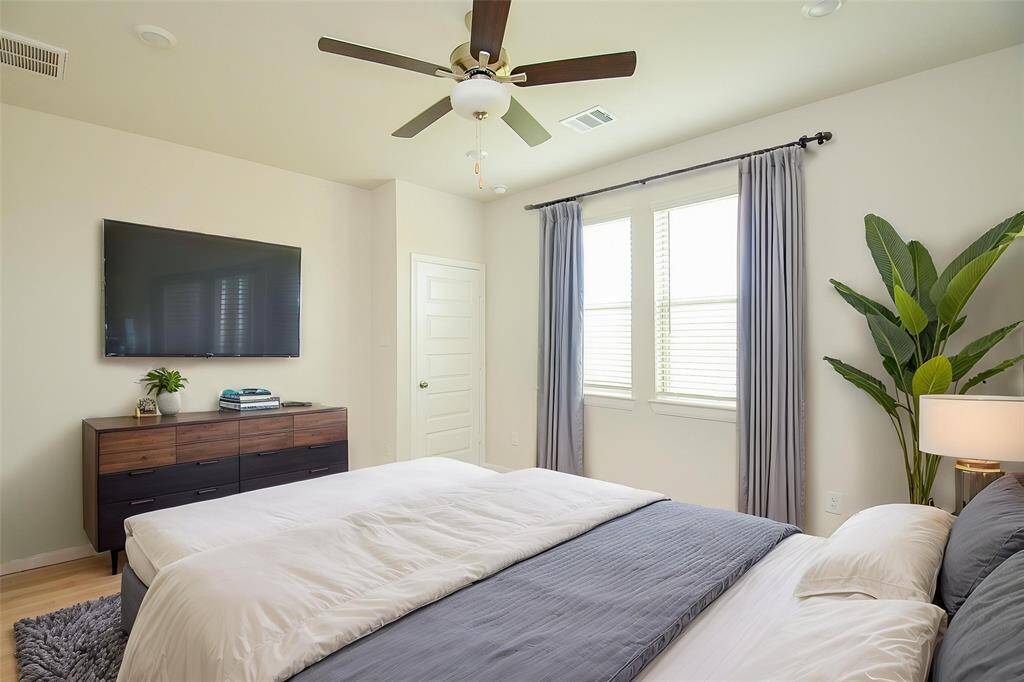 This spacious bedroom provides ample room for various layouts and personal touches.