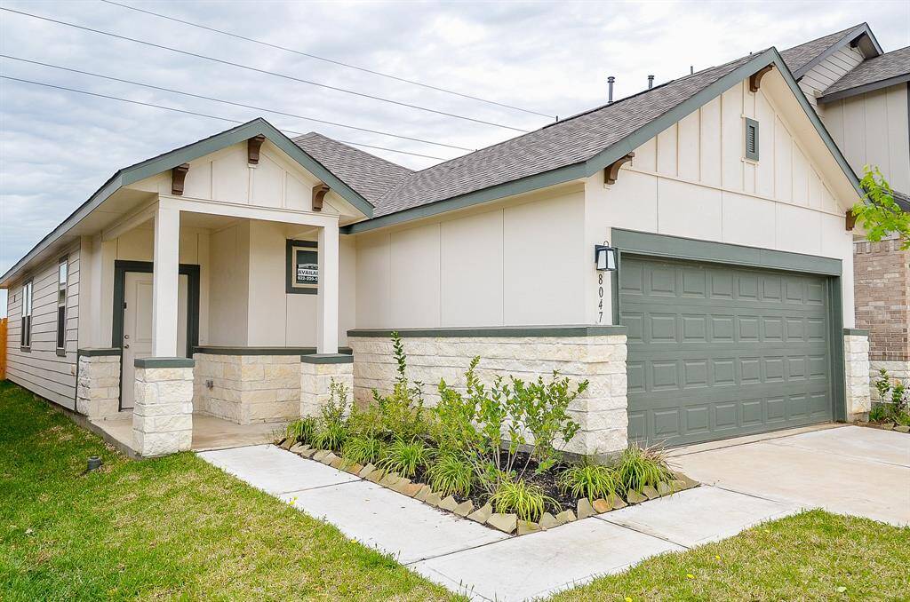 A striking combination of crisp white siding, contrasting trim, and a stylish garage door creates an inviting and sophisticated exterior.