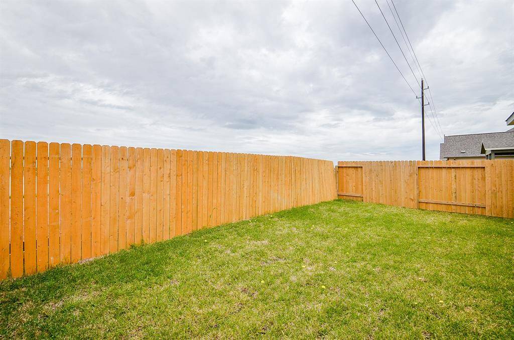 This fully-fenced and spacious backyard is perfect for family gatherings.