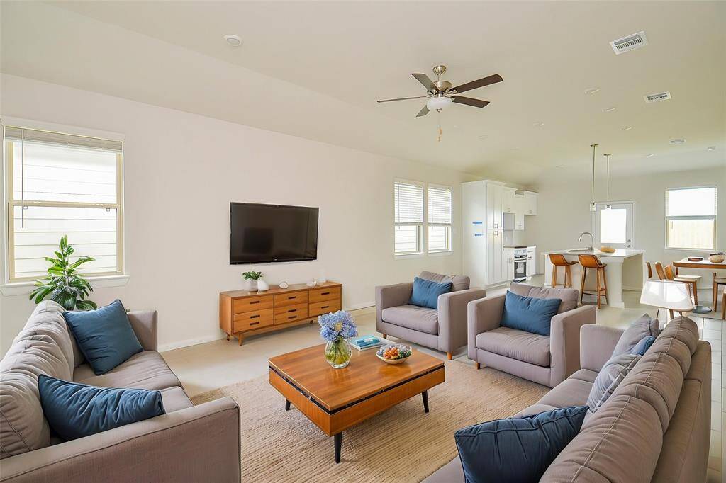 Notice the abundance of natural light, the soaring ceilings, and the seamless flow that makes this room perfect for relaxing and entertaining.