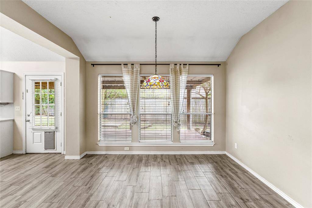 Dining room with 3 large windows for natural lighting.