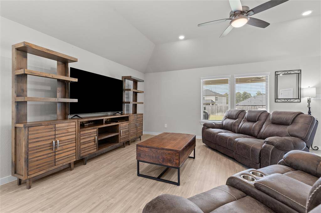 This living room allows for big furniture with plenty of room to spare!  Enjoy the view to the backyard
