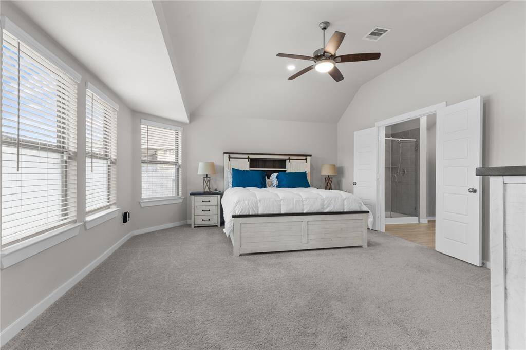 Primary Suite with additional bump out, which includes wall of windows!  2 inch blinds and Ceiling fans in all rooms
