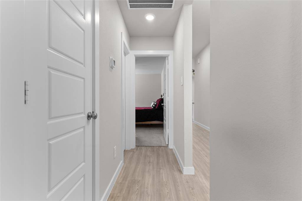 Front hallway leads to one of three  secondary bedrooms