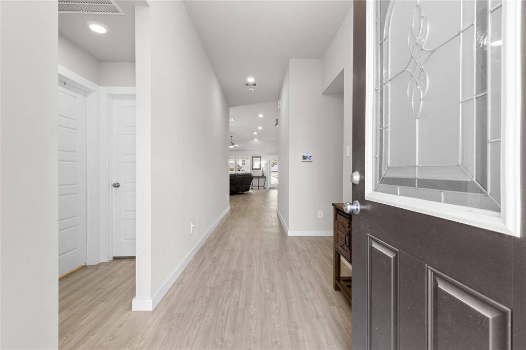 As you enter, you'll find 2 bedrooms and a full bath to your left