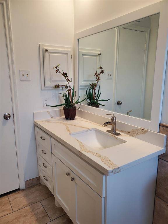 New vanity and mirror in hall bathroom