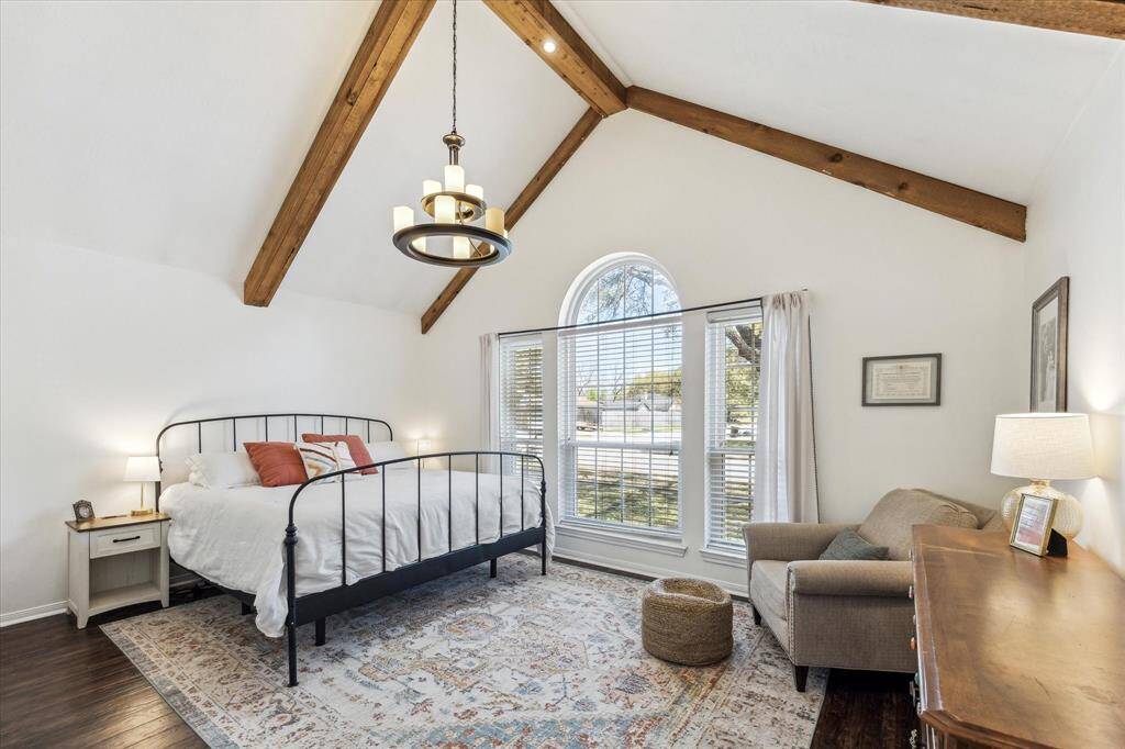 Primary Bedroom with vaulted ceiling and exposed beams