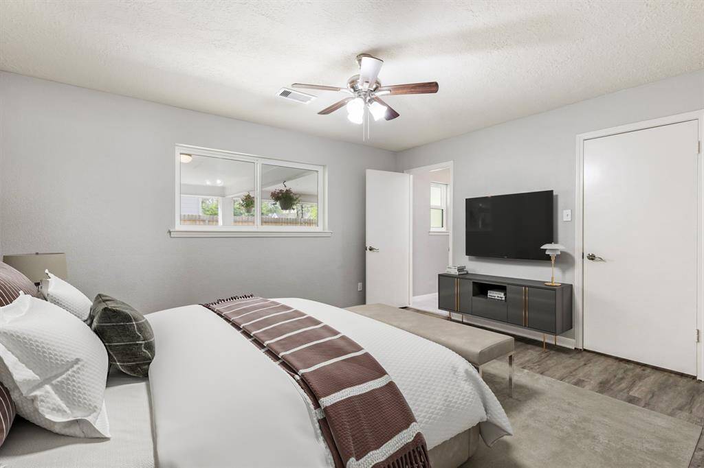 Primary Bedroom located down hallway to the right of home. Virtually staged. It features a large walk-in closet as well!