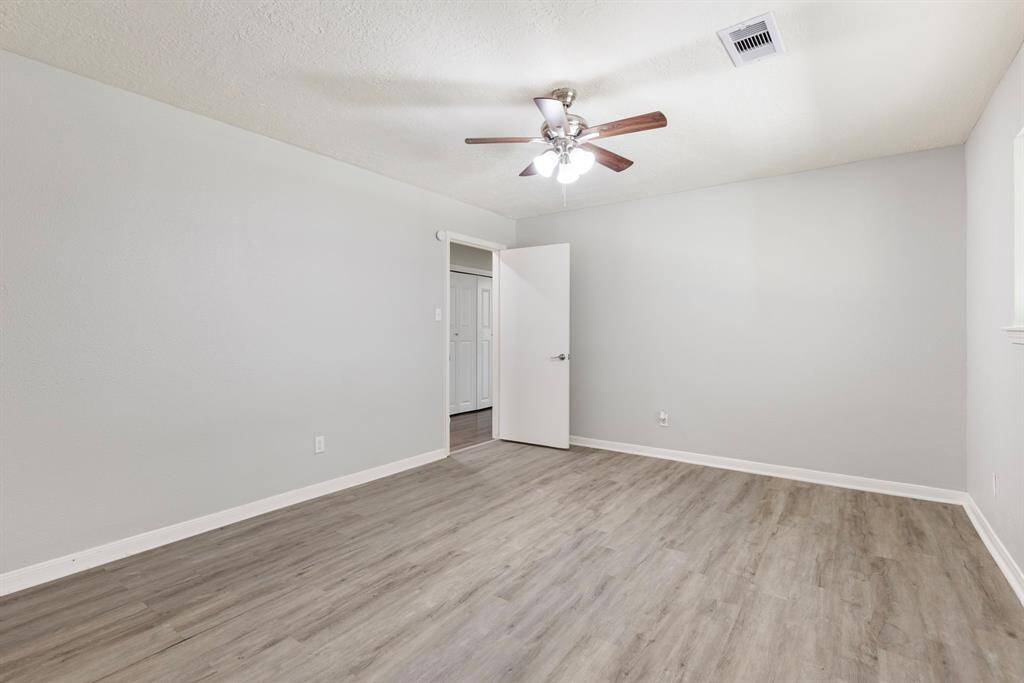 Primary Bedroom located down hallway to the right of home. It features a large walk-in closet as well!