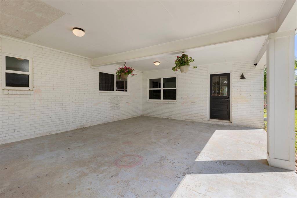 Large, covered back patio that overlooks the MASSIVE backyard.