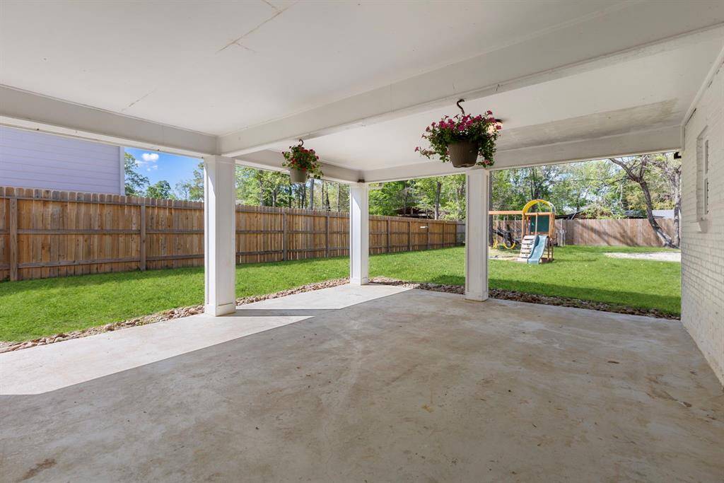 Large, covered back patio that overlooks the MASSIVE backyard.