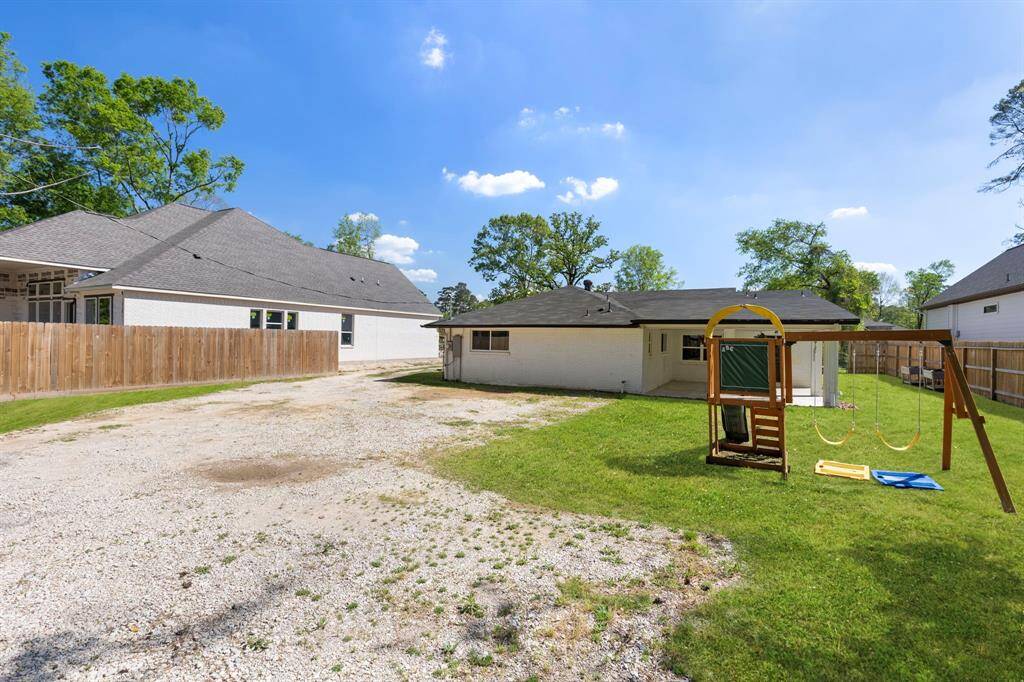 HUGE backyard with trees for privacy and a recent fence along the perimeter. Gravel was used for extra parking.