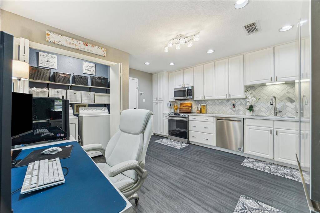 Kitchen with make-shift office space and dedicated laundry area