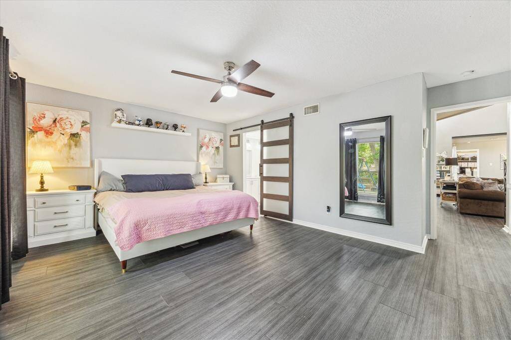 Barn door leads to updated en-suite and closet area