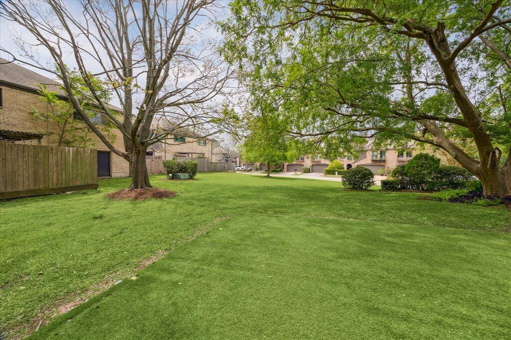 Backyard overlooks serene neighborhood green space