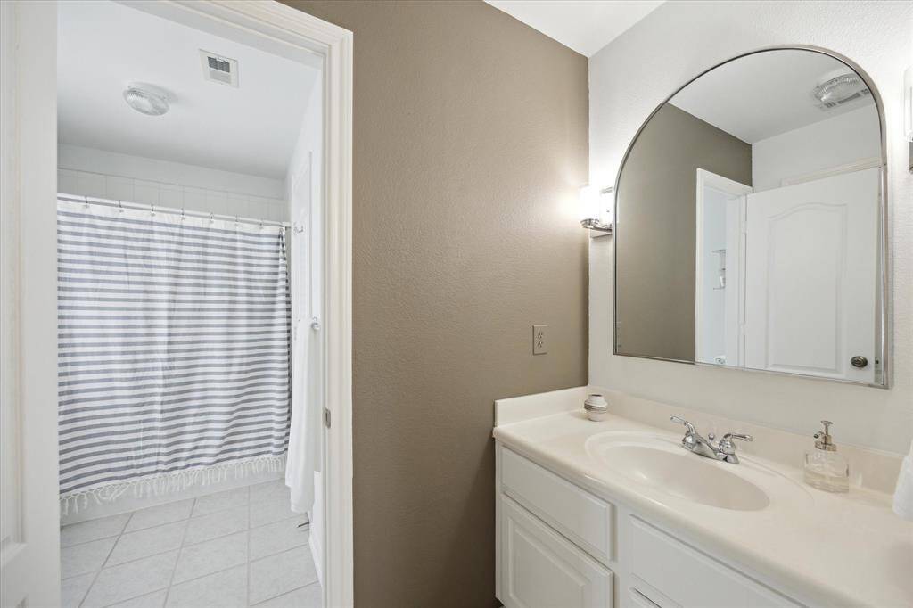 Located just off secondary bedroom one, this private vanity area offers added convenience and is connected to the Jack-and-Jill shared bathroom.