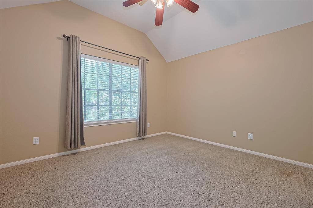 Bedroom 2 upstairs with ceiling fan and raised ceiling.