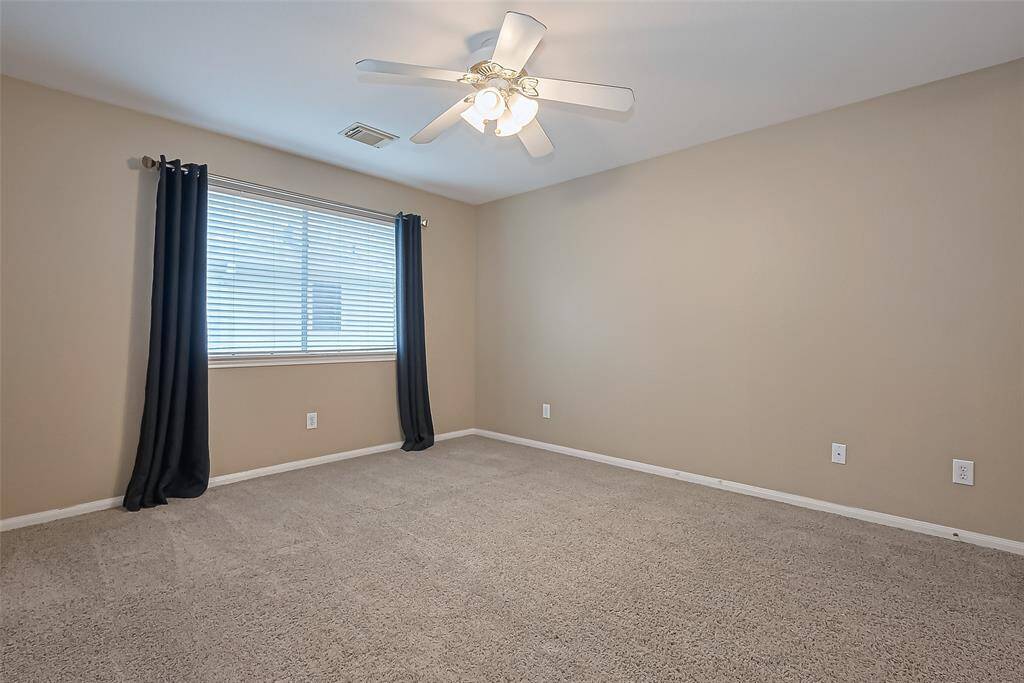 Bedroom 3 upstairs, again with ceiling fan. All windows include blinds and most have drapes as well.
