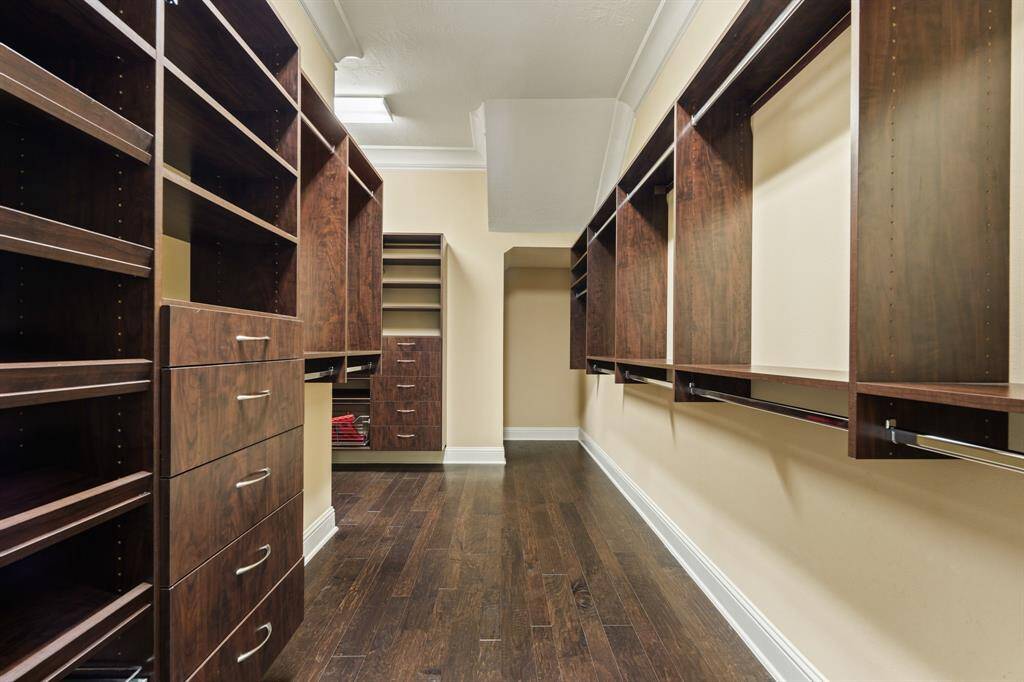 Primary walk-in closet with custom built-ins